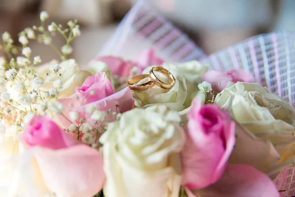 Gelinin nikah yüzüğü buketi. Yumuşak pembe ve bej çay gülleri romantik bir bukette toplanır.