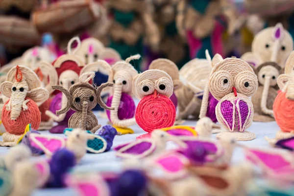 Indian traditional handmade puppet dolls made of jute isolated on blurred background is displayed in a street shop for sale. Indian handicraft and art