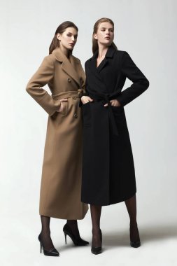 Stüdyoda zarif ceketlerle poz veren güzel moda kadınları