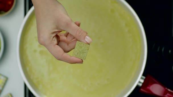 Woman Hand Throwing Seasoning Dice Soup — Stock Video