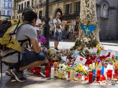 People in Barcelona pay tribute to the victims in terrorist attack. clipart