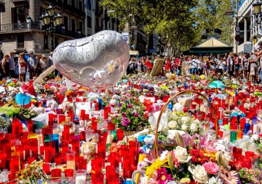 People in Barcelona pay tribute to the victims in terrorist attack. clipart