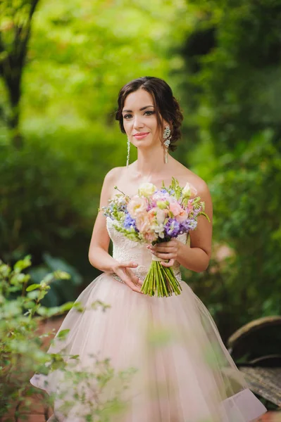 Portrait of a beautiful bride in park — Stok Foto