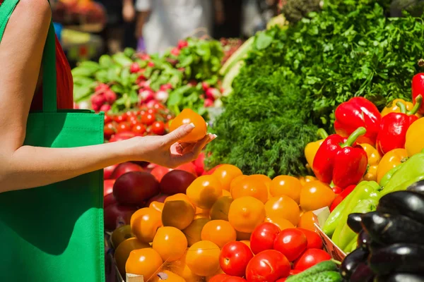 Woman buys tomatoes — Stock Photo, Image