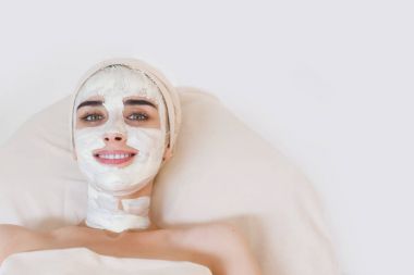Woman with facial clay mask clipart