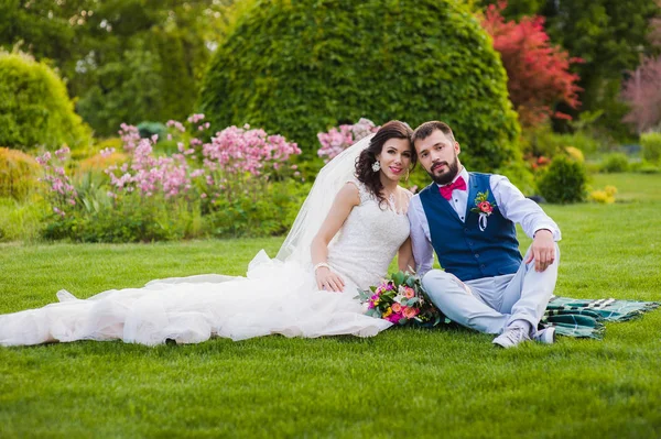 Casal lindo casal sentado na grama — Fotografia de Stock