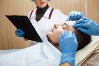 Doktorlar mavi kauçuk eldiven eller yüz dokunma