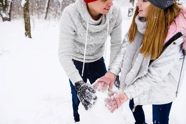 Aktivt par tonåringar att göra snögubbe — Stockfoto