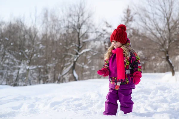 Little cute little girl on a snowy background — Stock Photo, Image