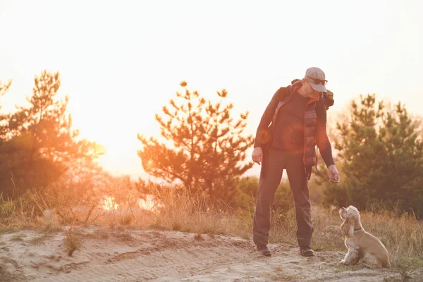 Tourist play with dog in sunset light