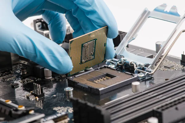 Male hand install cpu processor into motherboard — ストック写真