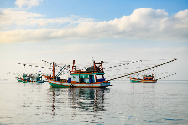 Beautiful view with four traditional bright fishing vessels at sea surface near Poda Chicken island, Thai
