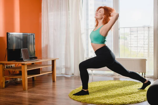 Young woman do sport stretch at home