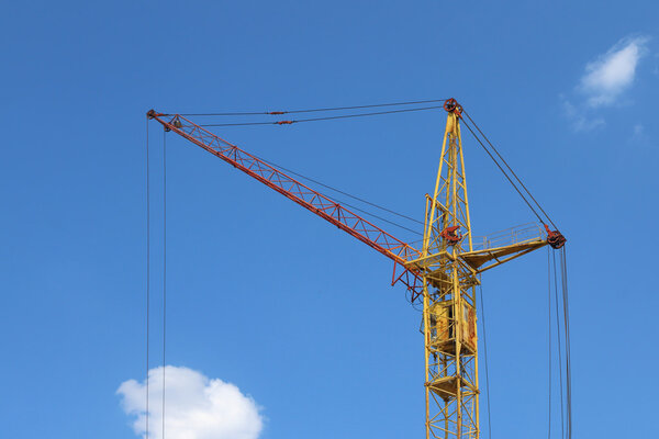 Part of stationary hoist on construction site, blue sky 