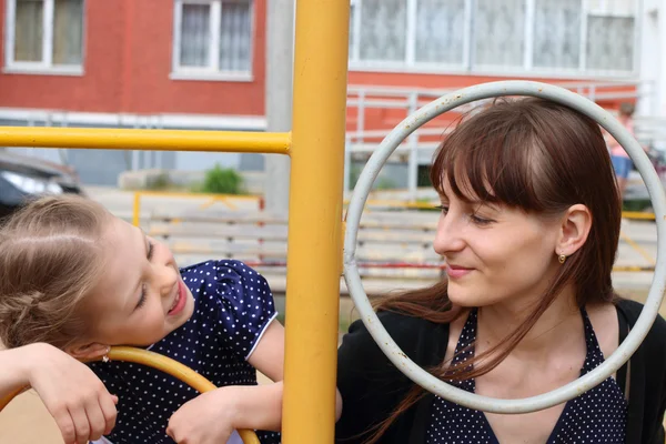 Little girl and her mother plays on children playground — Stock Photo, Image