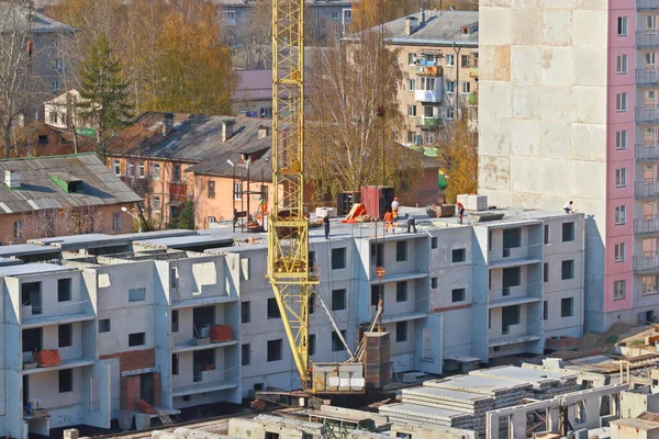 Crane part, workers on construction site Stock Picture