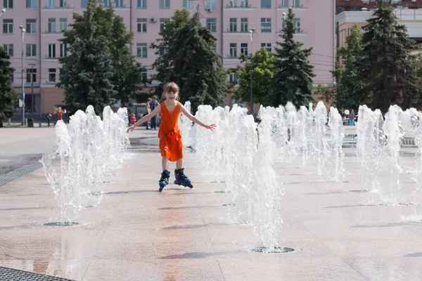 Szczęśliwa dziewczynka w mokrej sukni Wrotki w fontannie w summ — Zdjęcie stockowe