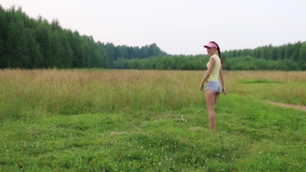 Mädchen turnt an Sommerabend Salto auf Wiese — Stockvideo