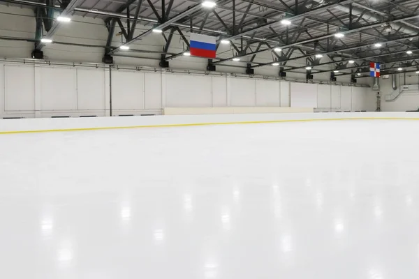 Big empty indoor new ice rick for competitions, hanging flags — Stock Photo, Image