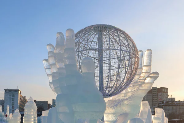 PERM, RUSSIA - JAN 18, 2017: Globe in hands art object, Ice town — Stock Photo, Image