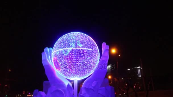 Globe in hands with illumination at evening, Ice town of Perm in 2017 Ekosad - largest in Russia — Stock Video