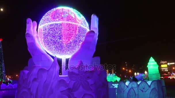 Earth in hands with illumination at evening, Ice town of Perm in 2017 Ekosad - largest in Russia — Stock Video