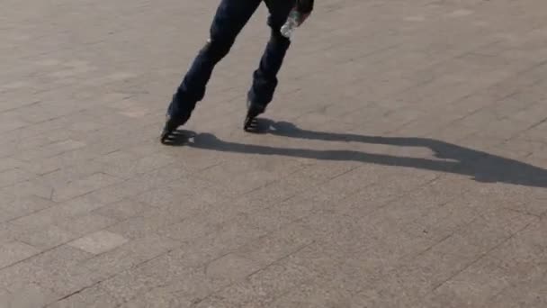 Mannelijke benen rolschaatsen op stoep op zomerdag in de stad — Stockvideo