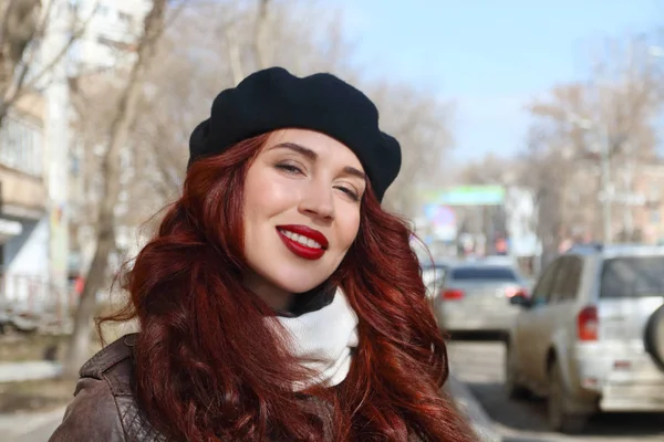 Deri ceket ve bere gülümsüyor sunn Caddesi'nde genç kadın