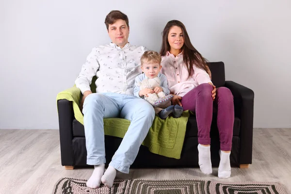 Young happy father, mother, little son sit on couch in living ro — Stock Photo, Image