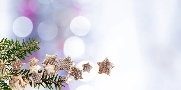 Kuusen oksa ja hämärtynyt jouluvalot taustalla — kuvapankkivalokuva