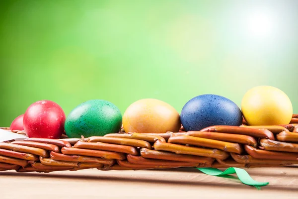 Colorful Easter eggs in a basket — Stock Photo, Image