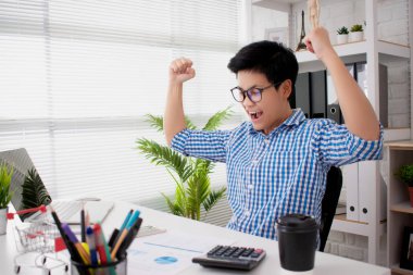Young business people wear blue plaid shirts, happy and satisfie