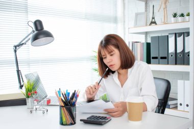 Young Asian businessmen are analyzing the graph in the office.