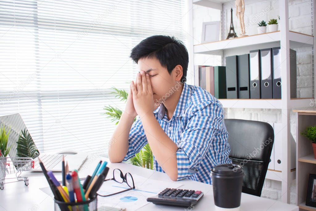 Young Asian businessmen are stressed from working hard all day working with laptops.