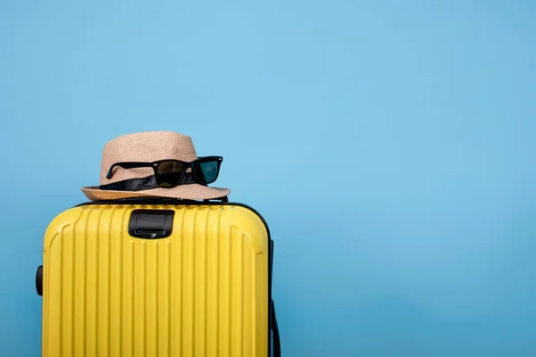 Closeup Yellow Suitcase Hat Sunglasses Bag Blue Background — Stock Photo, Image
