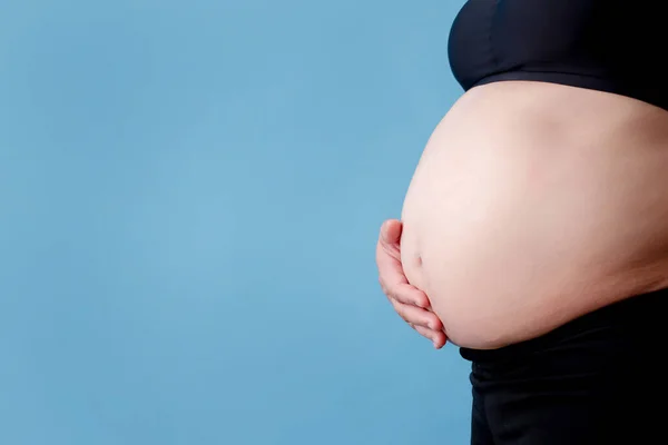 怀孕妇女的剖腹产是一种孤立的蓝色背景 — 图库照片
