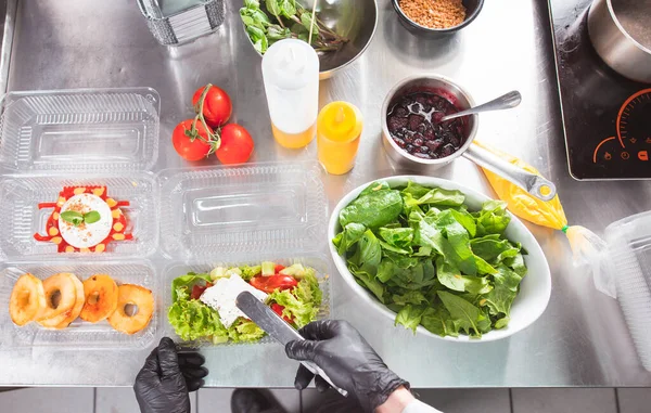 cooking in a restaurant and packing in a container for delivery