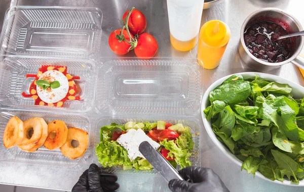 cooking in a restaurant and packing in a container for delivery