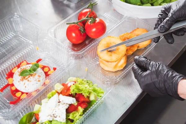 cooking in a restaurant and packing in a container for delivery