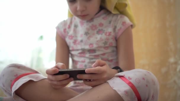 Child Enthusiastically Plays Mobile Game Holding Smartphone His Hands — Stock Video