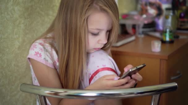 Girl Child Pajamas Sitting Chair Stares His Phone Girl Watching — Stock Video