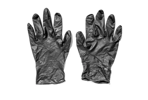Pár tenkých černých latexových rukavic na bílém pozadí. Použité jednorázové špinavé gumové rukavice. Ochranný předmět — Stock fotografie