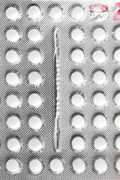 Gray aluminum blister with round pills and two empty cells — Stock Photo, Image