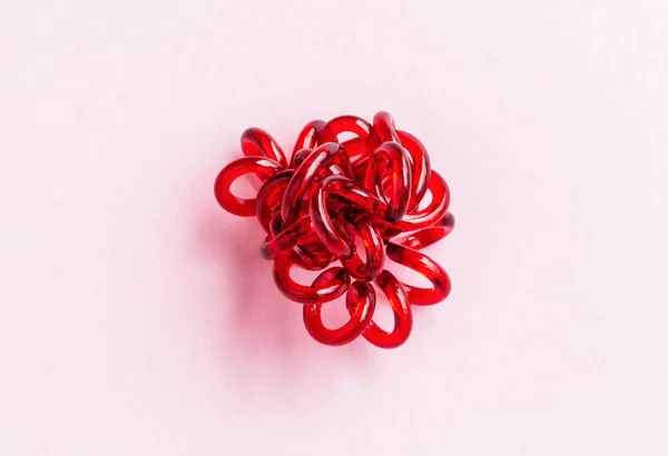 Cravates élastiques spirale rouge torsadées. Cravate élastique sur fond rose — Photo