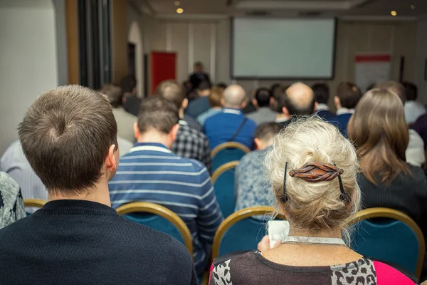 Full conference hall with people at the business conference, rear view — Stock Photo, Image