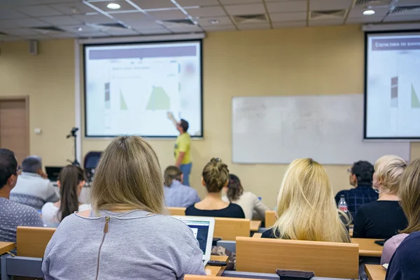 Education, high school, teamwork and people concept - teacher standing in front of students and showing graphs on white board in classroom — Stock Photo, Image