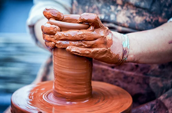 Hands of a potter, creating an earthen jar on the circle — Stock Photo, Image