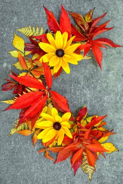 beautiful red and yellow autumnal leaves and flowers in a shape of half round clipart