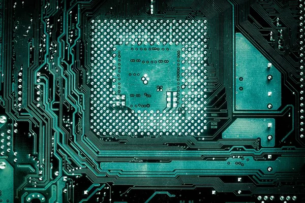 Abstract aged green computer circuit board close up for background.