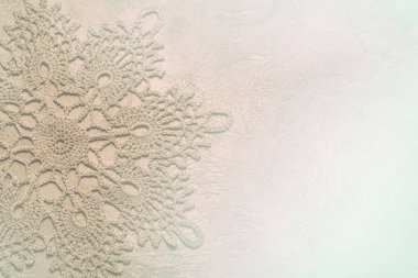 doily crochet tinted in subtle contours in neutral light beige colors, suitable for using as a background for a presentation or background on the theme of needlework, or as a wedding invitation card clipart